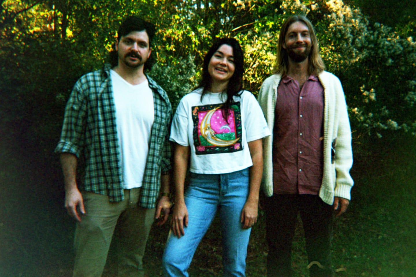 Polaroid of the band in front of trees